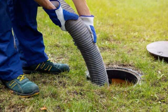 a person wearing gloves and holding a pipe