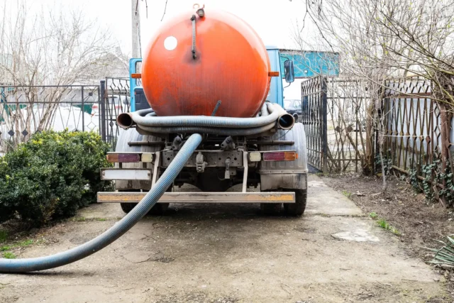 a truck with a large orange tank on the back