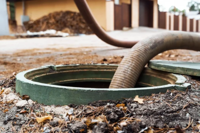 a pipe coming out of a sewer hole